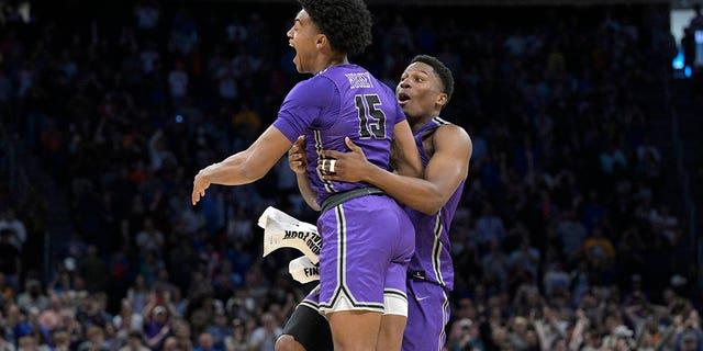 Furman forward Tyrese Hughey and forward Alex Williams celebrate their win against Virginia during a first-round game in the NCAA men's basketball tournament in Orlando, Fla., on Thursday.