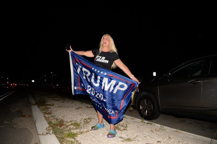 Women holding trump flag. 