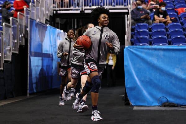 Christyn Williams leads UConn onto the court for its semifinal against Arizona.