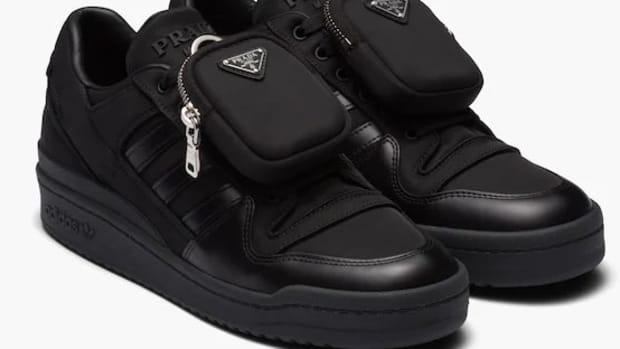 View of all black adidas forum low shoes.